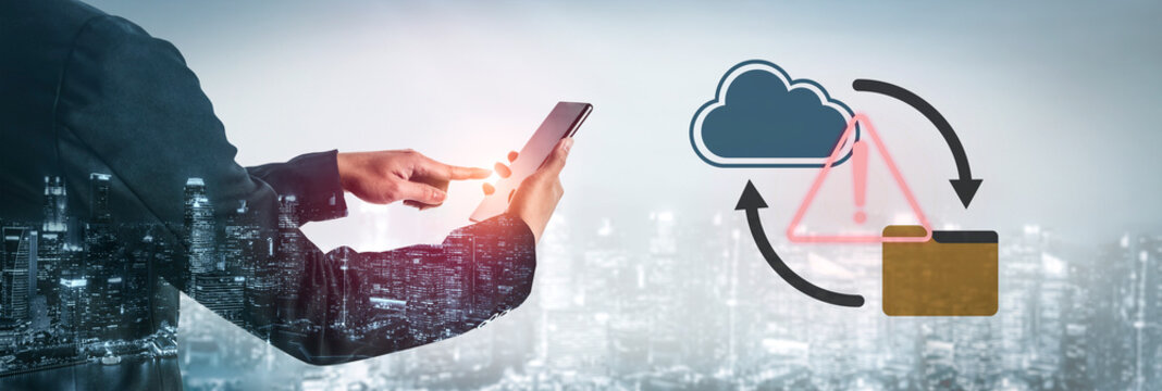 A businessman interacts with a smartphone displaying cloud technology and folder icons. The city skyline in the background highlights modern business and digital transformation themes. Gantry - Powered by Adobe