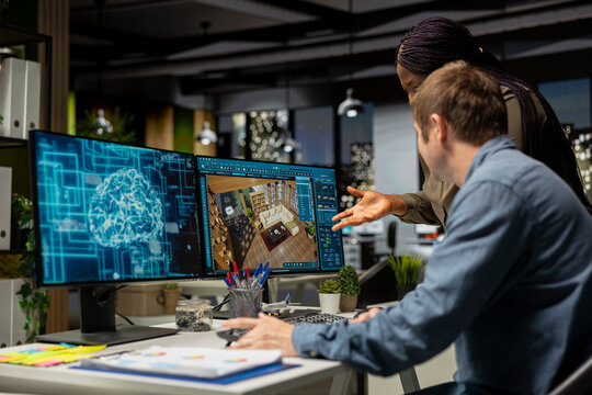 Diverse designers engineers using AI neural networks to help create interior design of a new apartment building, architectural software for a floor plan at workstation. Dual monitors. - Powered by Adobe