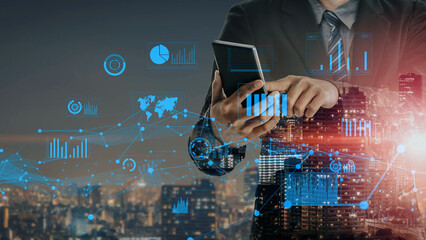 A business professional analyzes financial data on a smartphone, with city skyline and digital graphs in the background, blending technology and urban life. Xenic