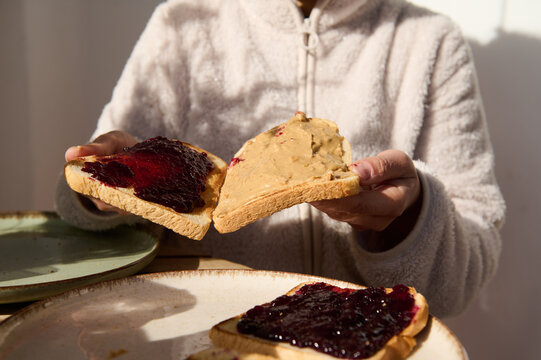 Cozy Breakfast Moment: Peanut Butter And Jelly Toast Slices Shared At The Table
