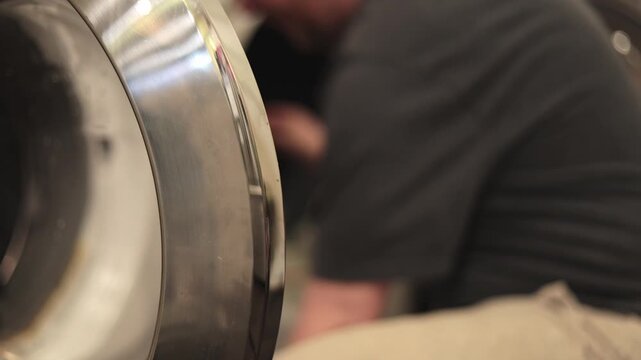 Side View of Pulling Clothes from Washer and Loading Dryer