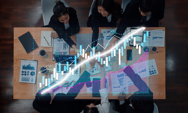 A business team collaborates in a modern office, analyzing financial data with charts and graphs to enhance their strategies and improve overall performance. Axiom - Powered by Adobe