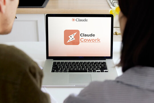 People viewing claude cowork ai technology application on laptop