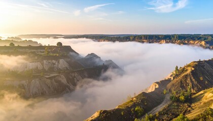 The mountains are covered with clouds and trees in the fore sun.