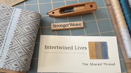 Weaving supplies and inspirational text arranged on a blue grid surface