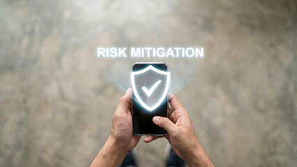 Risk mitigation business high level planning concept glow shield icon on mobile phone screen security idea