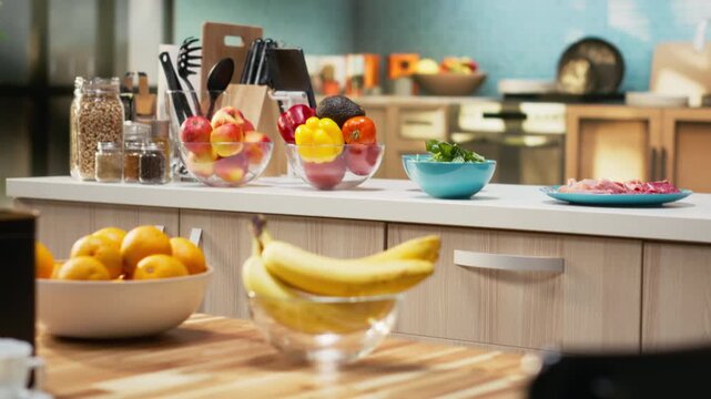 Rustic kitchen filled with fresh pizza ingredients on the countertop, including cheese, salami and pepperoni. Utensils and baking tools sit neatly arranged for homemade food preparation.