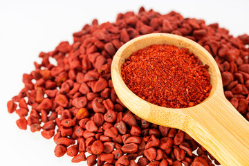 Bixa Orellana - Crushed annatto seeds in the measuring spoon