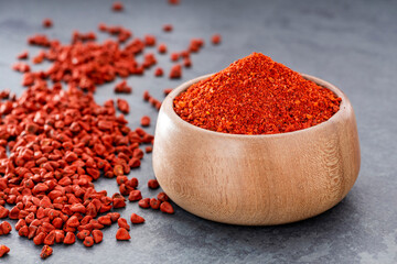 Bixa Orellana - Organic red annatto powder in a wooden bowl