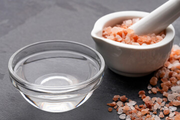 Coarse Himalayan pink salt in the bowl. Salt crystals for mixing with water.