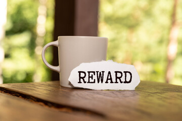 Concept of Rewards Card write on sticky notes isolated on Blue Table