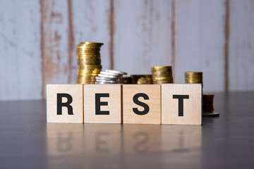 Miniature Shopping Cart Filled With Gold Coins Resting on Wooden Blocks Spelling CPI.