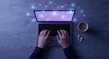 Hands typing on laptop keyboard with social media network icons and digital connection interface on wooden desk with coffee in top view for business and technology concept
