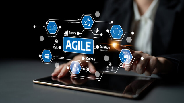 A business professional engages with a tablet featuring a visual representation of agile methodologies, including scrum and kanban, in a dark setting. Tessel - Powered by Adobe