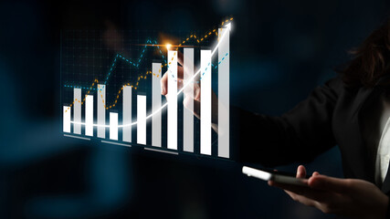 A business professional is using technology to monitor financial data with digital graphs and statistics. This image showcases the importance of data analysis in strategic decision-making. Impute