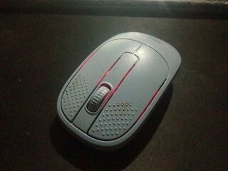 Modern Wireless Optical Mouse with Vibrant Red LED Backlight on Dark Background