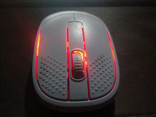 Modern Wireless Optical Mouse with Vibrant Red LED Backlight on Dark Background
