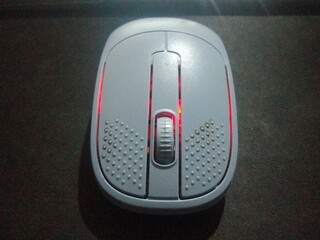 Modern Wireless Optical Mouse with Vibrant Red LED Backlight on Dark Background