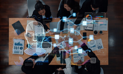 A diverse group of professionals collaborates on innovative technology in a modern workspace. Digital data visualization enhances discussion for strategic planning and AI development. Trope