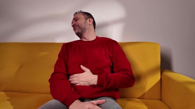 Man with gastritis, chest, stomach and abdominal pain at home.