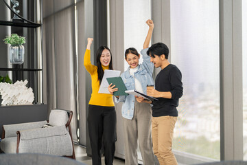 Asian business team celebrating success with raising fist in office, joyful expression teamwork spirit, multicultural collaboration, group achievement, workplace motivation, inclusive company