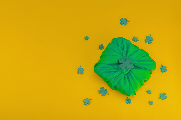Handmade St. Patrick's Day gift concept. Furoshiki, decorative symbols, crocheted leprechaun hat