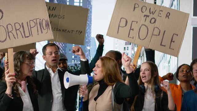 People protesting together during a strike and public march against corruption, holding posters and banners with warning messages about justice in a serious anti-corruption movement. Camera B.