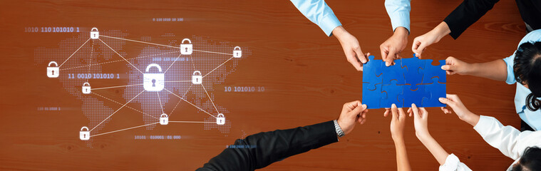 A collaborative team engaged in cybersecurity strategies, working together around a table with digital visuals highlighting data protection and network security. Trope