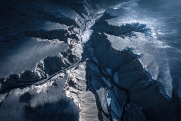 Winding river flowing through snow covered canyon