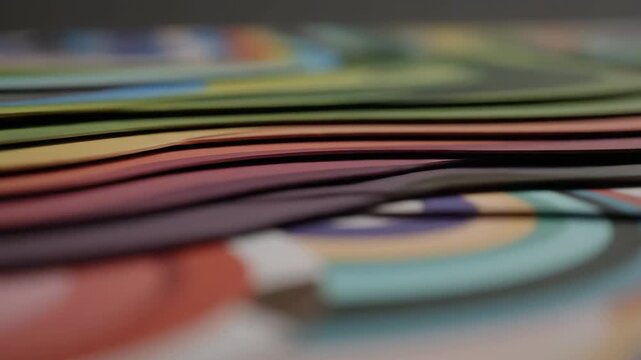 Dynamic close-up of colorful wavy paper layers moving subtly, forming an abstract and vibrant background.