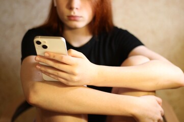 Young teenager pretty girl with smartphone in her hands 