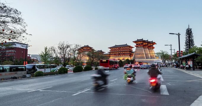 Time-lapse from dusk to night at Yingtian Gate and Dingding Avenue, blending history, urban energy, and glowing cityscapes, Luoyang City, Henan Province, China