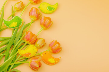 Gentle Easter composition with tulips flowers and handmade felt birds. Traditional elements