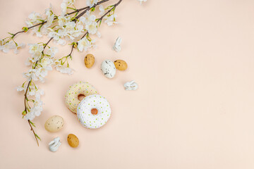 Handmade crocheted donuts with blooming cherry branches. Festive Easter, greeting card