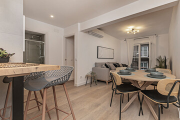 A bright and airy living room where natural light floods the space through large windows,...