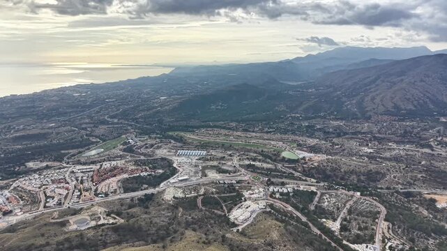 Aerial Valley Under Heavy Cloud Cover, Geologist Survey Flight Observing Winding Roads And Scattered