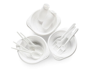 Plastic bowls with cutlery and bottles on white background