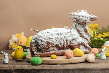 Easter lamb cake with traditional spring decor. Baked sweet dessert with icing. Festive background