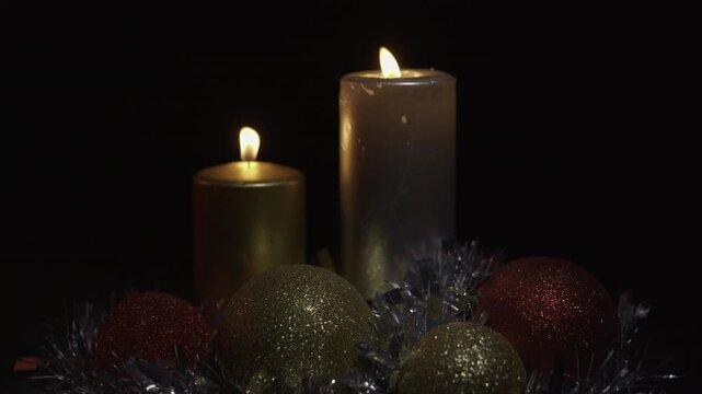 Christmas decoration with two candles and silver tinsel garland