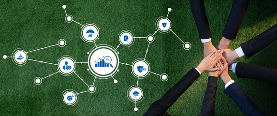 This image showcases a diverse team collaborating on management strategies against a green background, emphasizing teamwork, growth, and data analysis for business success. Amity