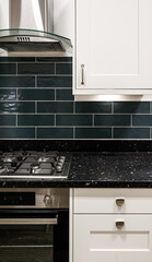 Obraz premium Modern kitchen interior, dark green subway tile, black granite countertop, white cabinets, gas hob, oven
