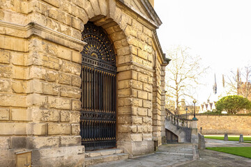 Ornate iron gate entrance to the Sheldonian Theatre in Oxford, England, a historic architectural...