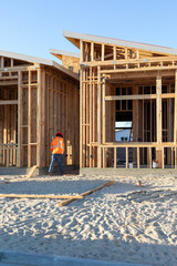 Fototapeta premium Modern wood frame construction and a construction worker