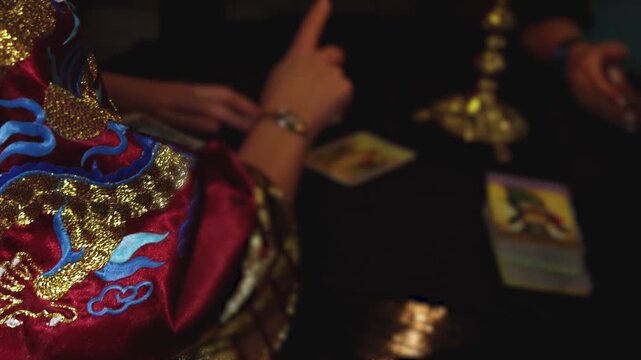 Process of tarot card reading and future fate prediction, fortune teller medium with a deck of divination cards tells a destiny forecast, female tarot reader fortune telling, esoteric and astrology