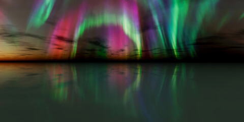 Obraz premium Vibrant Aurora Borealis Over Sunset Reflection in Water, Dreamlike Night Sky