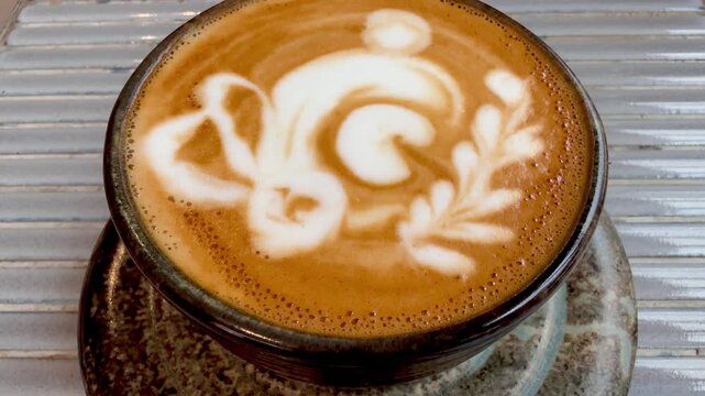 Froth art in a cup of magic coffee