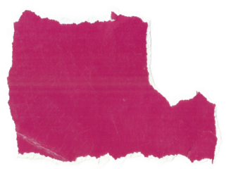 Torn magenta paper scrap on dark surface