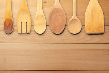 Wooden Utensils on Wooden Surface Background. File with Clipping Path.