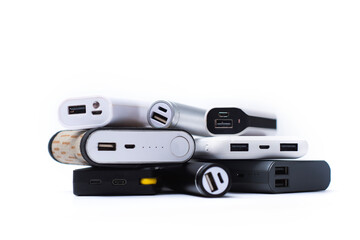 Assortment of stylish portable power banks in white, silver, black, fabric and modern designs...