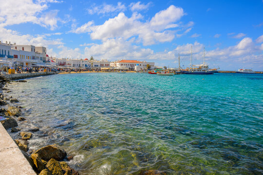 The sandy Paralia Choras Mikonou beach and seaside promenade of cafes and shops at Mykonos Town, or Chora, on the island of Mykonos Greece.